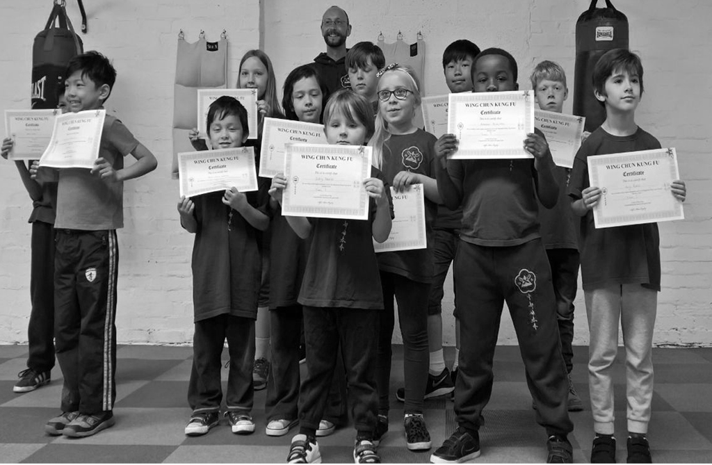 Children at Wing Chun Halesowen holding their Wing Chun Kung Fu certificates